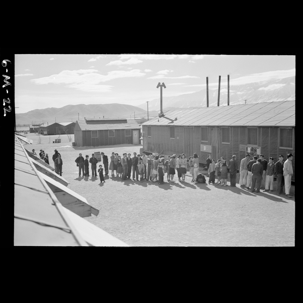 Relocated Japanese Americans line up for food at the Manzanar relocation center during World War 2.
