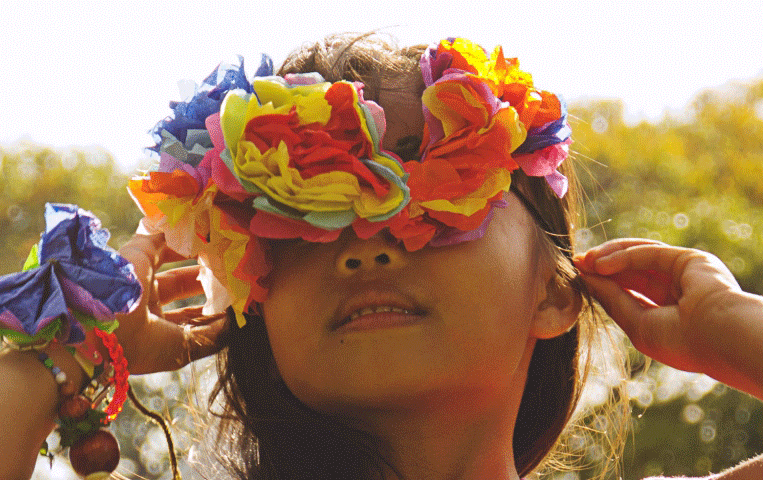 Women with colorful flowers over her eyes.